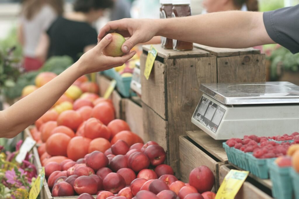 Someone buying fruit at a local market