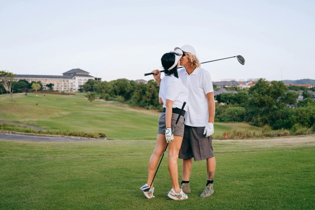 a couple sharing a kiss on a golf course